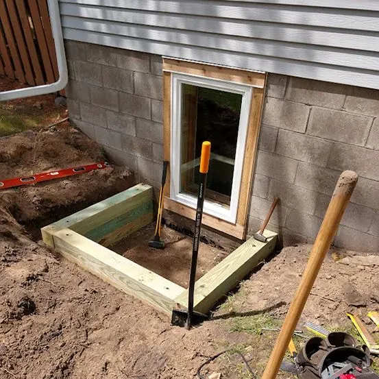 Completed residential egress window replacement in a concrete block foundation