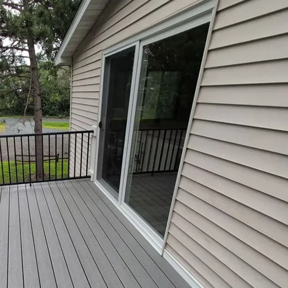New sliding patio door installed beside a residential deck