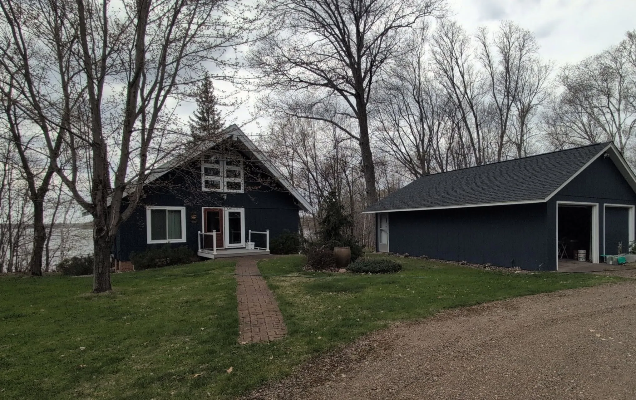 Completed dark asphalt shingle roof replacement on a residential home with steep rooflines